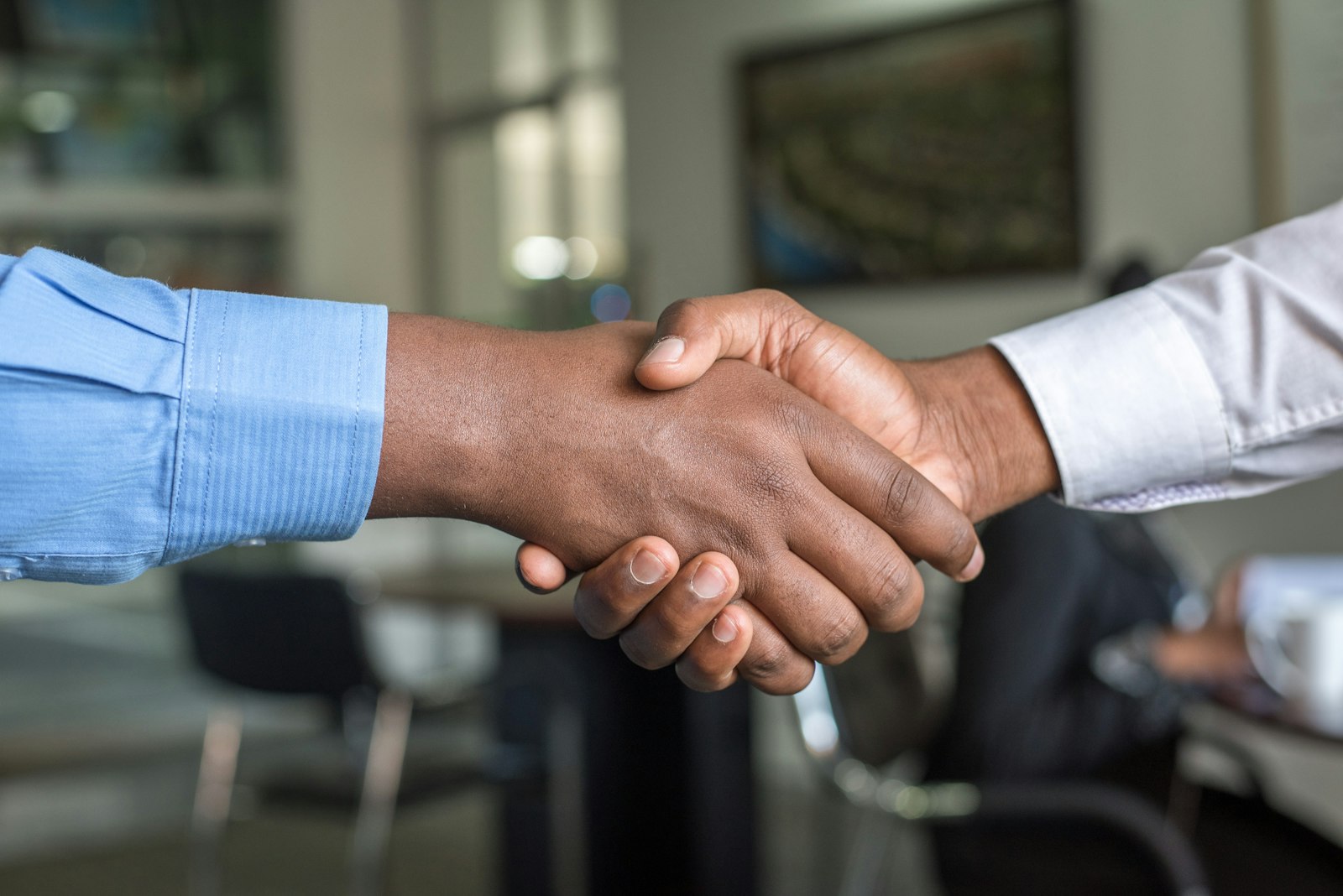Two business people shaking hands in an office