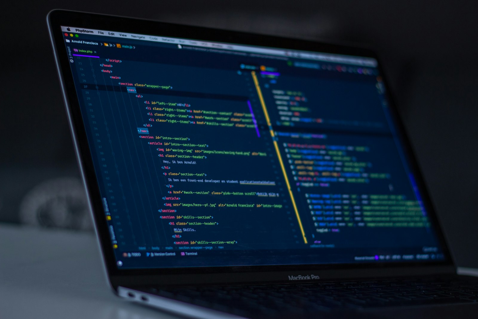 Source code on a laptop screen in a dark room